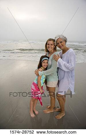 Portrait of a grandmother standing with her daughter and granddaughter at the beach View Large Photo Image Stock Image - Portrait of a grandmother standing with her daughter and granddaughter at the beach. Fotosearch
