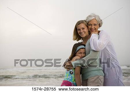 Portrait of a grandmother standing with her daughter and granddaughter at the beach View Large Photo Image Stock Photography - Portrait of a grandmother standing with her daughter and granddaughter at the beach. Fotosearch