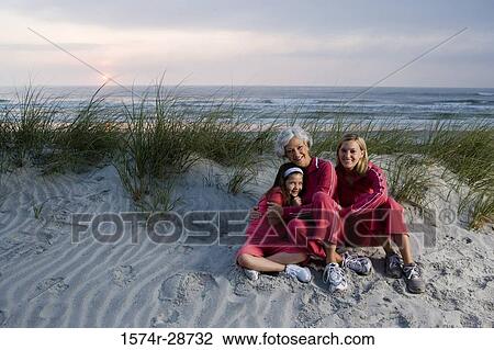 Portrait of a grandmother with her daughter and granddaughter sitting at the beach View Large Photo Image Stock Image - Portrait of a grandmother with her daughter and granddaughter sitting at the beach. Fotosearch