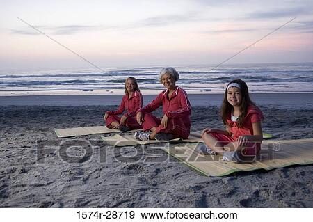Portrait of a grandmother with her daughter and granddaughter exercising at the beach View Large Photo Image Stock Photo - Portrait of a grandmother with her daughter and granddaughter exercising at the beach. Fotosearch