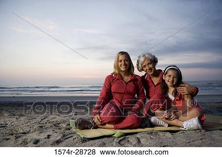 Portrait of a grandmother with her daughter and granddaughter sitting on a mat at the beach View Large Photo Image Stock Photo - Portrait of a grandmother with her daughter and granddaughter sitting on a mat at the beach. Fotosearch