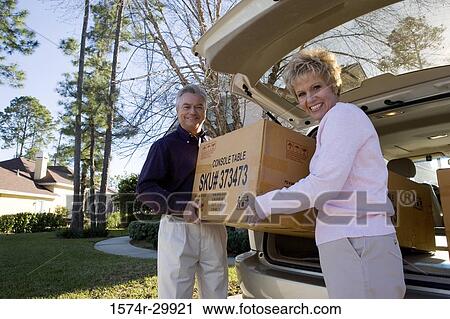 Portrait of a mature couple removing a cardboard box from a car View Large Photo Image Stock Image - Portrait of a mature couple removing a cardboard box from a car. Fotosearch