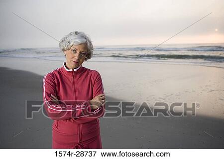 Portrait of a mature woman standing at the beach View Large Photo Image Stock Photo - Portrait of a mature woman standing at the beach. Fotosearch