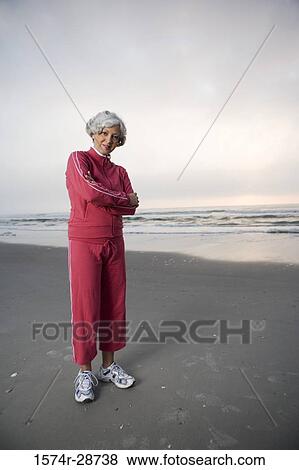 Portrait of a mature woman standing at the beach View Large Photo Image Stock Photo - Portrait of a mature woman standing at the beach. Fotosearch