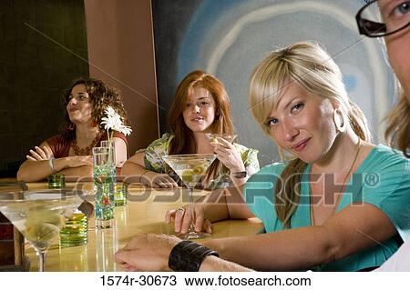 Portrait of a mature woman with daughters by bar counter View Large Photo Image Stock Image - Portrait of a mature woman with daughters by bar counter. Fotosearch
