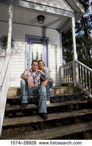 Portrait of a mid adult couple sitting on the staircase View Large Photo Image Stock Photo - Portrait of a mid adult couple sitting on the staircase. Fotosearch