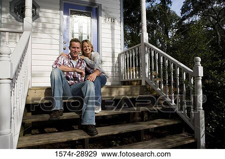 Portrait of a mid adult couple sitting on the staircase View Large Photo Image Stock Photo - Portrait of a mid adult couple sitting on the staircase. Fotosearch