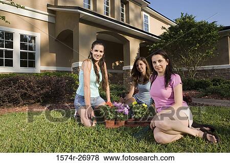 Portrait of a mother gardening with her daughters in garden View Large Photo Image Stock Photo - Portrait of a mother gardening with her daughters in garden. Fotosearch