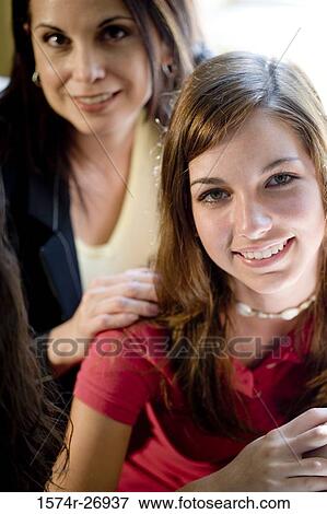 Portrait of a mother smiling with her daughter View Large Photo Image Stock Photo - Portrait of a mother smiling with her daughter. Fotosearch