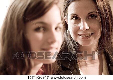 Portrait of a mother smiling with her daughter View Large Photo Image Stock Photo - Portrait of a mother smiling with her daughter. Fotosearch