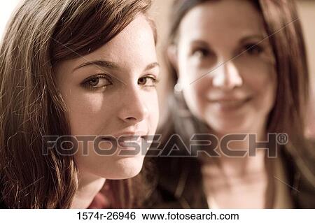 Portrait of a mother smiling with her daughter View Large Photo Image Stock Photograph - Portrait of a mother smiling with her daughter. Fotosearch