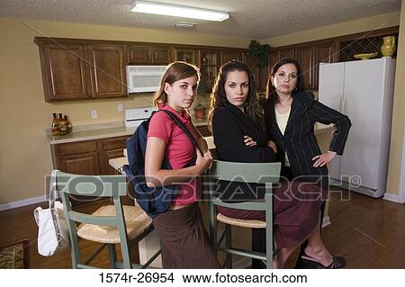 Portrait of a mother standing with daughters in kitchen View Large Photo Image Picture - Portrait of a mother standing with daughters in kitchen. Fotosearch
