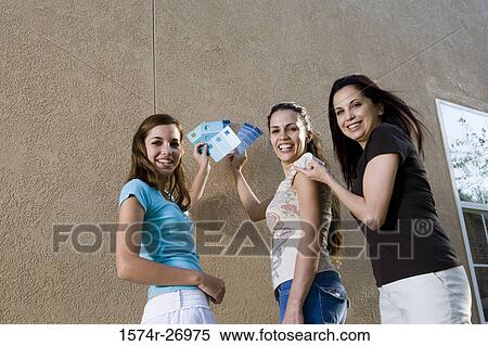 Portrait of a mother with her daughters holding color swatches against wall View Large Photo Image Stock Photography - Portrait of a mother with her daughters holding color swatches against wall. Fotosearch
