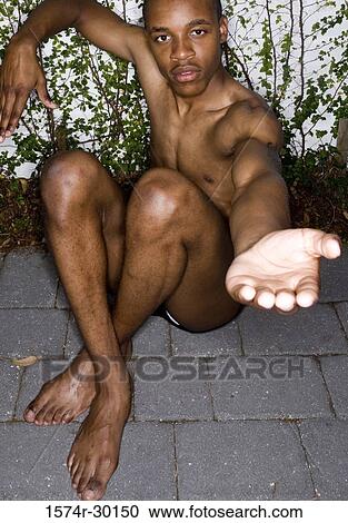 Portrait of a shirtless man sitting on floor and gesturing View Large Photo Image Stock Image - Portrait of a shirtless man sitting on floor and gesturing. Fotosearch