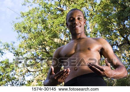 Portrait of a shirtless man standing under the trees and smiling View Large Photo Image Stock Photography - Portrait of a shirtless man standing under the trees and smiling. Fotosearch