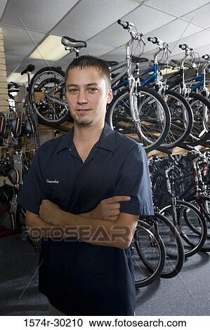 Portrait of a smiling man in a bicycle shop View Large Photo Image Stock Image - Portrait of a smiling man in a bicycle shop. Fotosearch