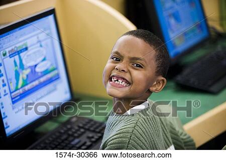 Portrait of a smiling schoolboy making face View Large Photo Image Stock Photograph - Portrait of a smiling schoolboy making face. Fotosearch