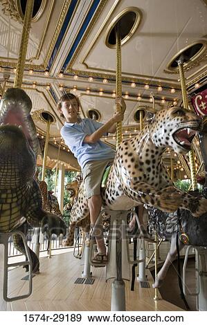 Portrait of a teenage boy sitting on a carousel leopard View Large Photo Image Stock Photo - Portrait of a teenage boy sitting on a carousel leopard. Fotosearch
