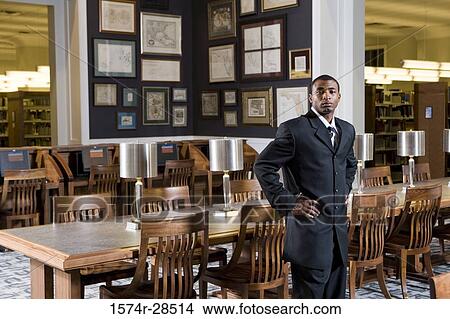 Picture - Portrait of a well-dressed businessman standing in an office. Fotosearch
