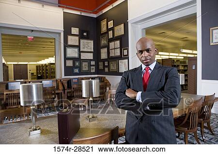 Portrait of a well-dressed businessman standing in an office View Large Photo Image Stock Image - Portrait of a well-dressed businessman standing in an office. Fotosearch