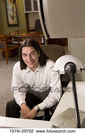 Portrait of a young businessman sitting in an office View Large Photo Image Stock Image - Portrait of a young businessman sitting in an office. Fotosearch