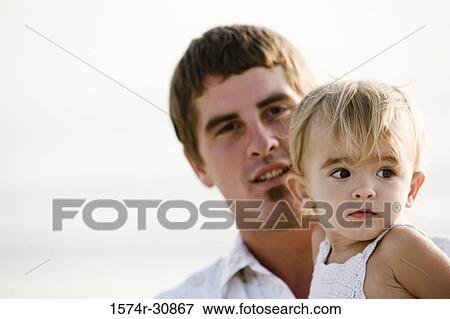 Portrait of a young man and his daughter with sea in the background View Large Photo Image Stock Photo - Portrait of a young man and his daughter with sea in the background. Fotosearch