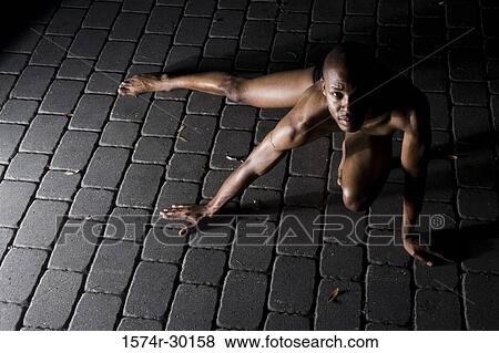 Portrait of a young man crawling on tiled floor View Large Photo Image Stock Photo - Portrait of a young man crawling on tiled floor. Fotosearch