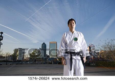 Portrait of a young man in sports clothing standing on the road View Large Photo Image Picture - Portrait of a young man in sports clothing standing on the road. Fotosearch