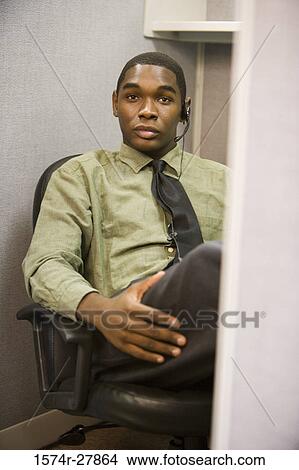 Portrait of a young man wearing headset in an office View Large Photo Image Picture - Portrait of a young man wearing headset in an office. Fotosearch