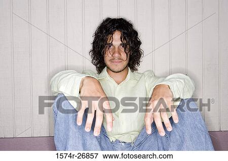 Stock Photo - Portrait of a young man with curly hair. Fotosearch