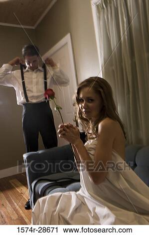 Portrait of a young prostitute holding a rose while mid adult man wearing clothes View Large Photo Image Stock Image - Portrait of a young prostitute holding a rose while mid adult man wearing clothes. Fotosearch