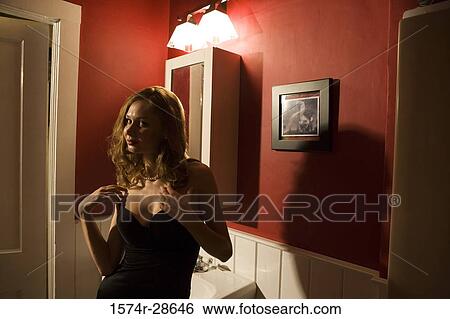 Portrait of a young prostitute in a gown standing by sink View Large Photo Image Stock Photograph - Portrait of a young prostitute in a gown standing by sink. Fotosearch