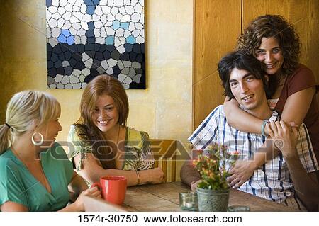 Portrait of a young woman embracing her brother while sister and mother sitting beside View Large Photo Image Stock Image - Portrait of a young woman embracing her brother while sister and mother sitting beside. Fotosearch