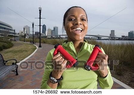 Portrait of a young woman in sports clothing jogging on walkway View Large Photo Image Stock Image - Portrait of a young woman in sports clothing jogging on walkway. Fotosearch