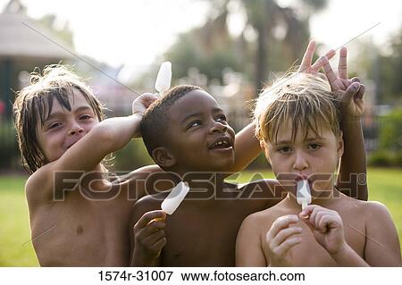Portrait of bare chested boys eating flavored ice View Large Photo Image Stock Photo - Portrait of bare chested boys eating flavored ice. Fotosearch