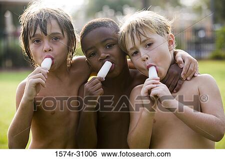 Portrait of bare chested boys eating flavored ice View Large Photo Image Stock Photograph - Portrait of bare chested boys eating flavored ice. Fotosearch