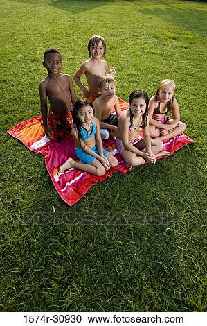 Portrait of boys and girls sitting on a towel View Large Photo Image Stock Image - Portrait of boys and girls sitting on a towel. Fotosearch