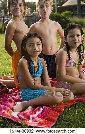 Portrait of boys and girls sitting on a towel View Large Photo Image Stock Image - Portrait of boys and girls sitting on a towel. Fotosearch