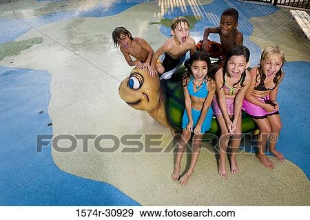 Portrait of boys and girls sitting together on a tortoise sculpture View Large Photo Image Stock Photo - Portrait of boys and girls sitting together on a tortoise sculpture. Fotosearch
