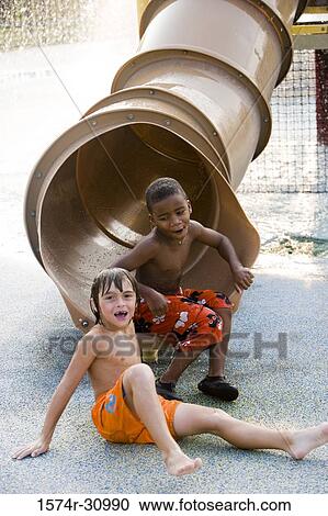 Portrait of boys sitting by tunnel slide View Large Photo Image Stock Image - Portrait of boys sitting by tunnel slide. Fotosearch