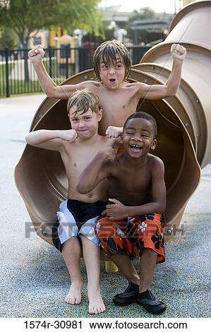 Portrait of boys sitting together at end of a slide View Large Photo Image Stock Image - Portrait of boys sitting together at end of a slide. Fotosearch
