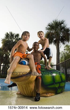 Portrait of boys sitting together on a tortoise sculpture View Large Photo Image Picture - Portrait of boys sitting together on a tortoise sculpture. Fotosearch