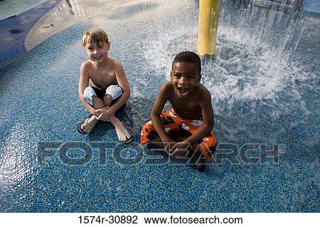 Portrait of boys sitting under a shower View Large Photo Image Stock Image - Portrait of boys sitting under a shower. Fotosearch