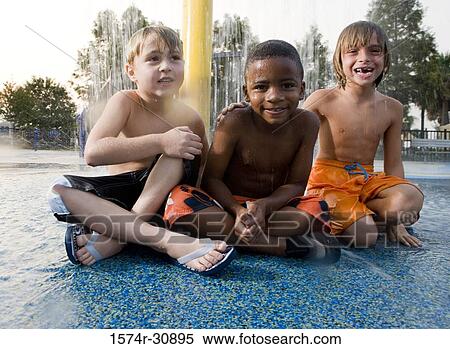 Portrait of boys sitting under a shower View Large Photo Image Stock Photography - Portrait of boys sitting under a shower. Fotosearch