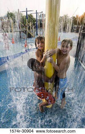 Portrait of boys standing under a shower View Large Photo Image Picture - Portrait of boys standing under a shower. Fotosearch