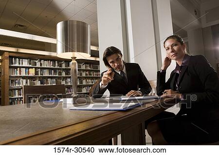 Portrait of business people discussing in an office View Large Photo Image Stock Image - Portrait of business people discussing in an office. Fotosearch