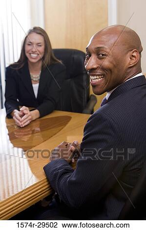 Portrait of business people in full suit smiling in an office View Large Photo Image Stock Image - Portrait of business people in full suit smiling in an office. Fotosearch