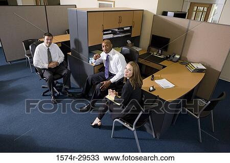 Stock Image - Portrait of business people sitting in an office. Fotosearch