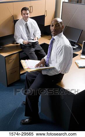 Stock Photography - Portrait of business people sitting in an office. Fotosearch