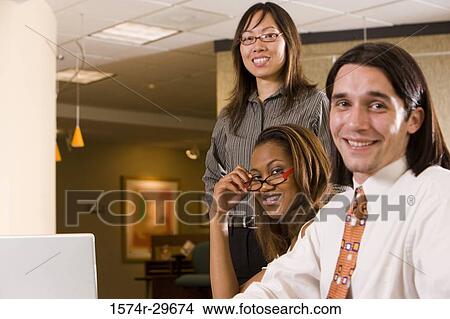 Portrait of businessman and businesswomen sitting in office View Large Photo Image Picture - Portrait of businessman and businesswomen sitting in office. Fotosearch